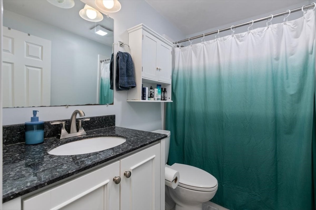 25 Clark's Road, Unit 101 Amesbury, MA 01913 - Photo 19 of 32 a bathroom with a granite countertop sink and a mirror