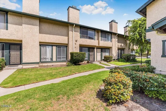 a view of a house with a yard and plants
