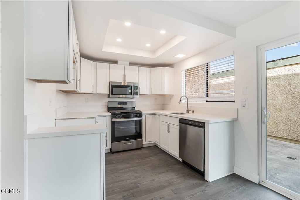 5147 Perkins Road Oxnard, CA 93033 - Photo 12 of 42 a kitchen with stainless steel appliances granite countertop a sink and a stove