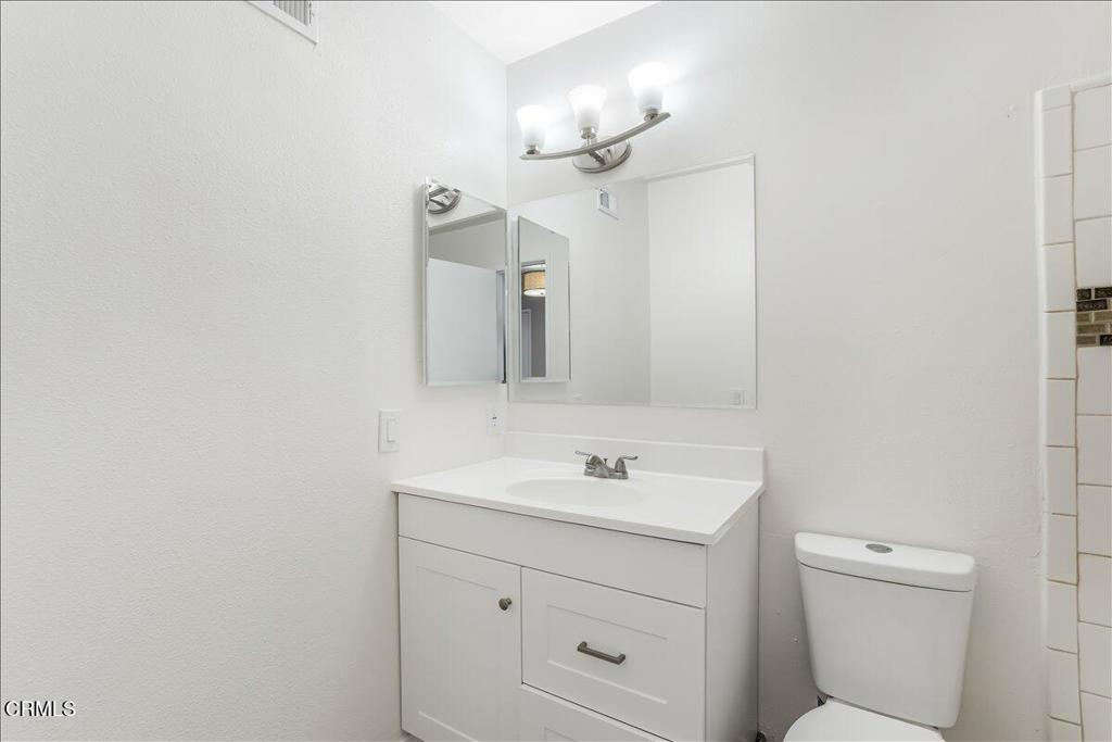 5147 Perkins Road Oxnard, CA 93033 - Photo 22 of 42 a bathroom with a sink a toilet and a mirror