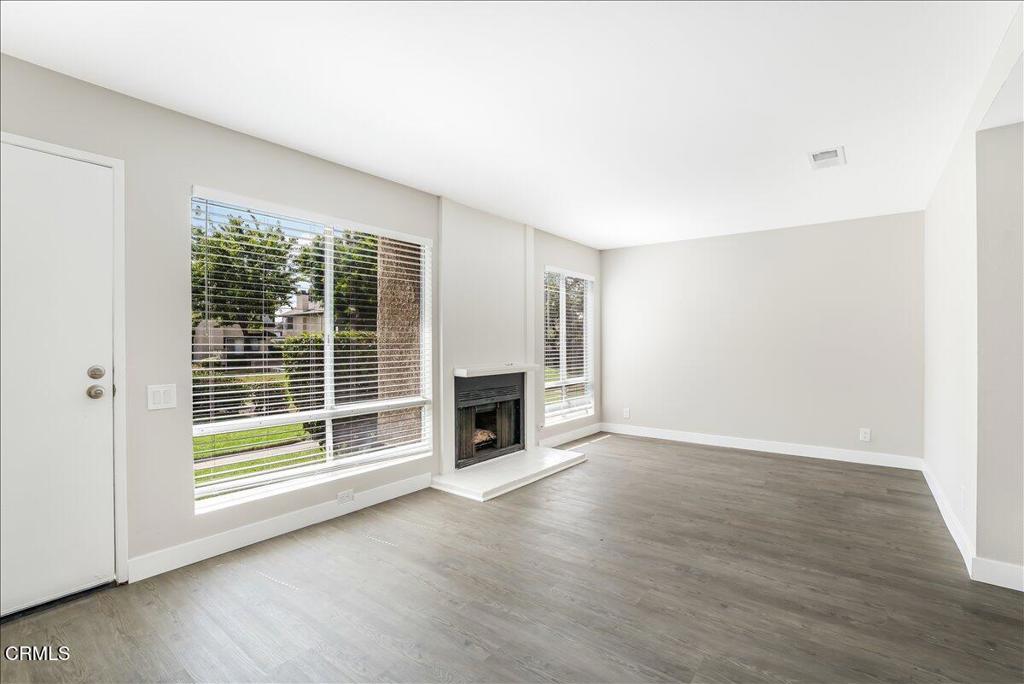 5147 Perkins Road Oxnard, CA 93033 - Photo 5 of 42 a view of a livingroom with a fireplace wooden floor and window