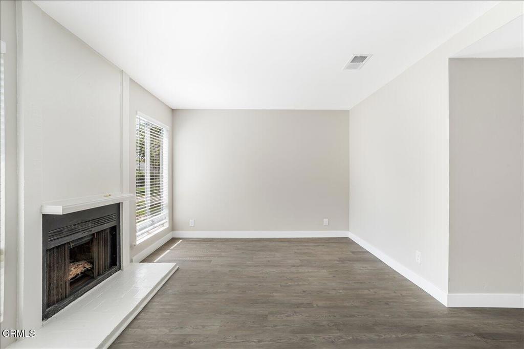 5147 Perkins Road Oxnard, CA 93033 - Photo 6 of 42 an empty room with windows and fireplace