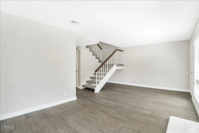 a view of an entryway with wooden floor