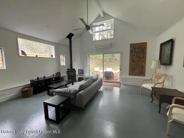 a living room with furniture wooden floor and a flat screen tv