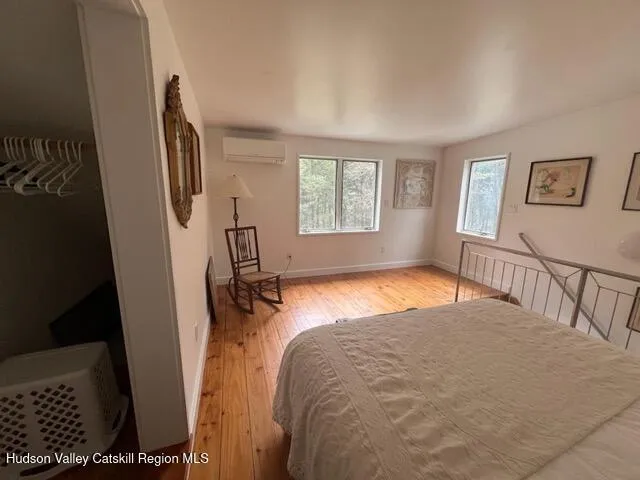 a bedroom with a bed next to a window