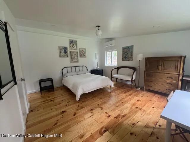 a bedroom with a bed and a desk