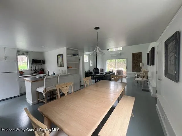 a large kitchen with a table and chairs