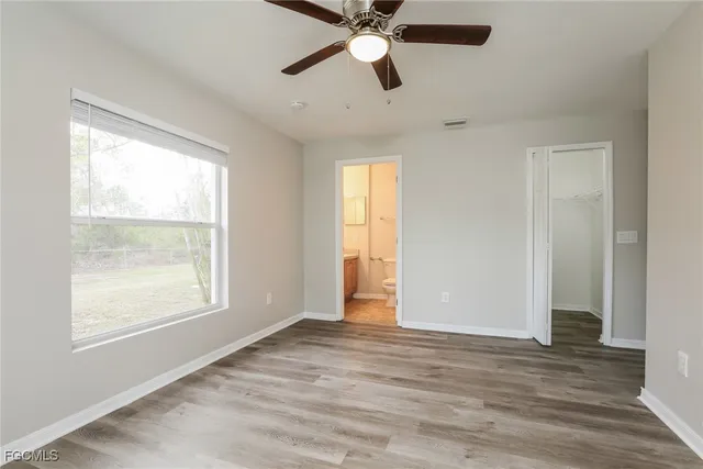 a bathroom with a granite countertop sink mirror vanity and toilet