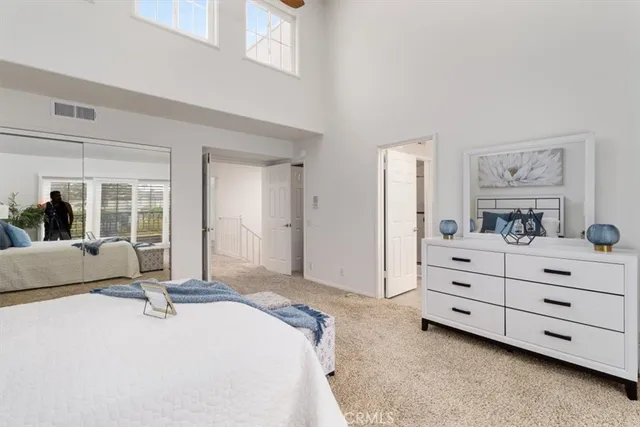 a bed room with a bed and a mirror