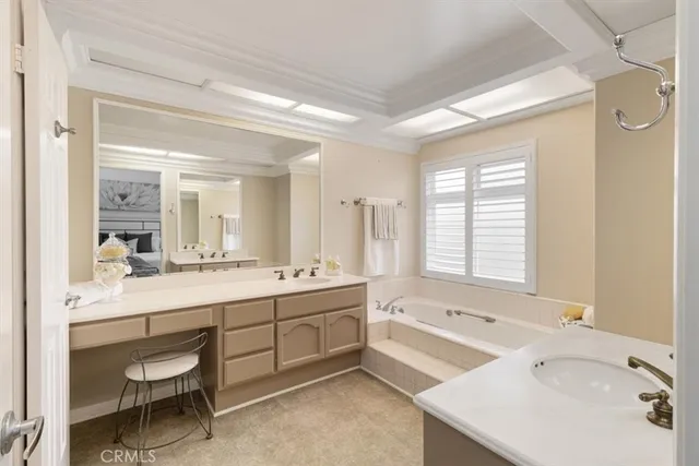 a bathroom with a tub sink and mirror