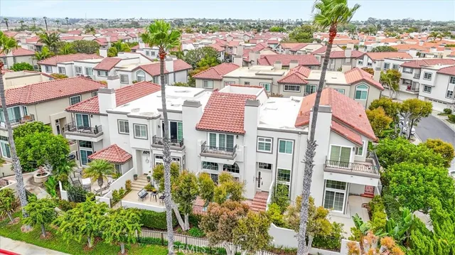an aerial view of residential houses with cars parked in front of it