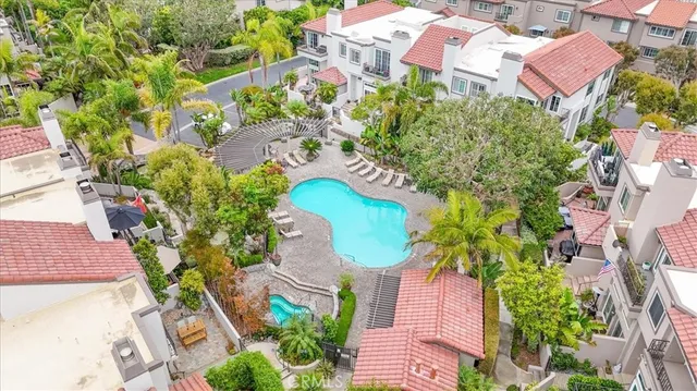 an aerial view of a house with swimming pool and porch