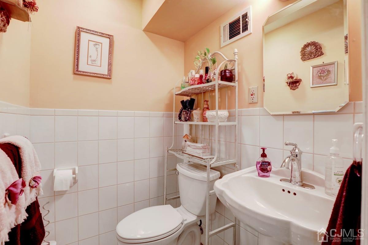 19 North Rhoda Street Monroe Township, NJ 08831 - Photo 12 of 26 a bathroom with a sink mirror and toilet