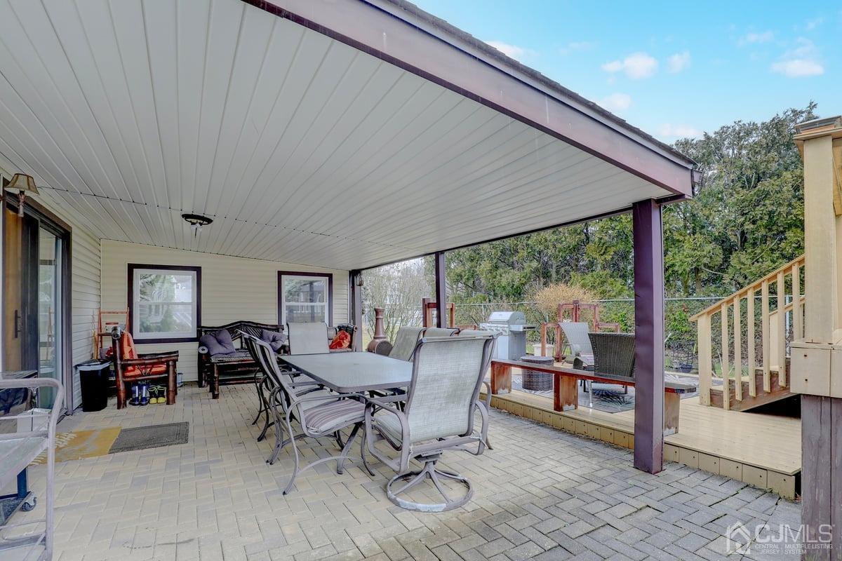 19 North Rhoda Street Monroe Township, NJ 08831 - Photo 21 of 26 a view of a patio with a table chairs and backyard
