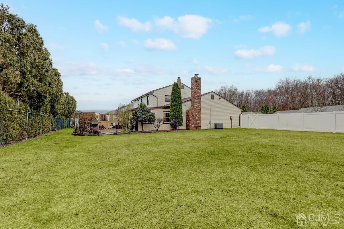 19 North Rhoda Street Monroe Township, NJ 08831 - Photo 25 of 26 a backyard of a house with lots of green space and mountain view in back