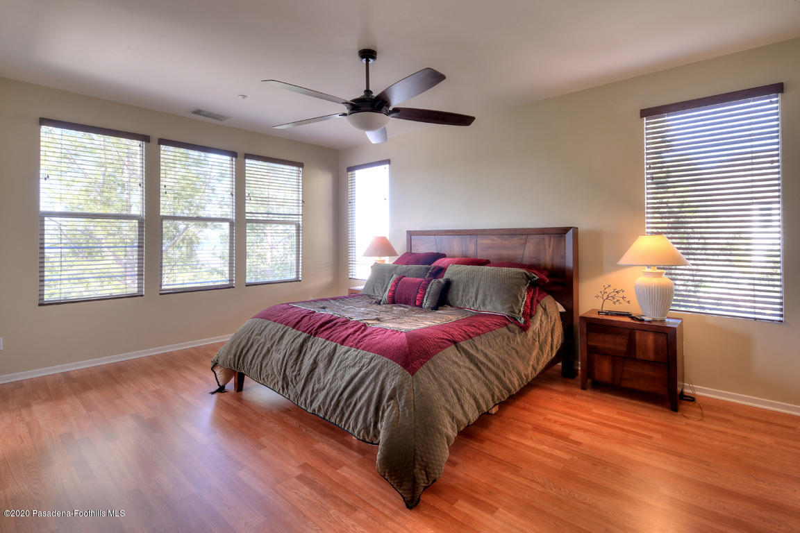 7461 Chanteclair Court Tujunga, CA 91042 - Photo 21 of 44 a bedroom with a bed and wooden floor
