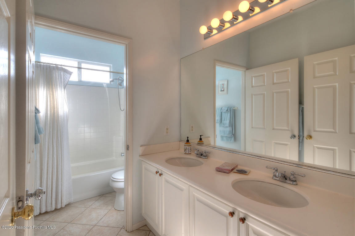 7461 Chanteclair Court Tujunga, CA 91042 - Photo 25 of 44 a bathroom with a double vanity sink and a mirror