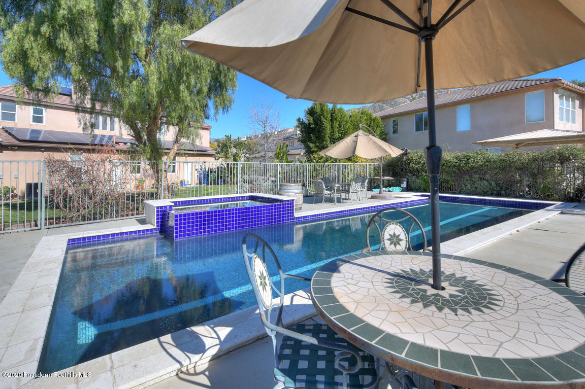 7461 Chanteclair Court Tujunga, CA 91042 - Photo 30 of 44 a view of a patio with table and chairs potted plants