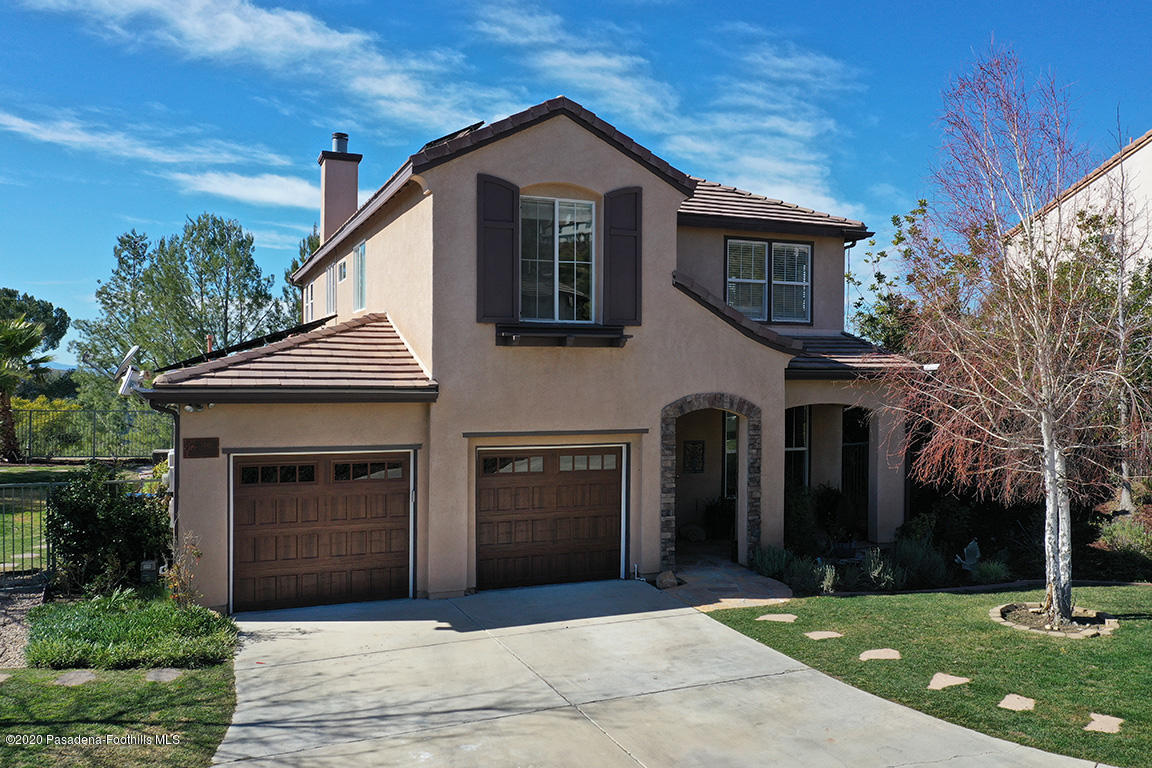 7461 Chanteclair Court Tujunga, CA 91042 - Photo 35 of 44 a front view of a house with yard and garage