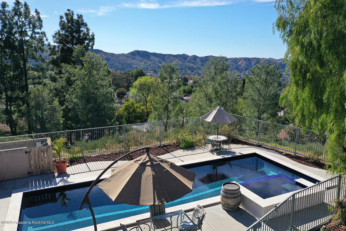 7461 Chanteclair Court Tujunga, CA 91042 - Photo 36 of 44 a view of a roof deck with couches and wooden floor