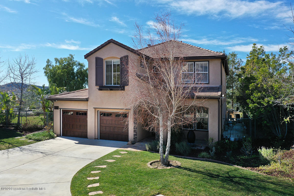 7461 Chanteclair Court Tujunga, CA 91042 - Photo 43 of 44 a front view of a house with a garden and yard