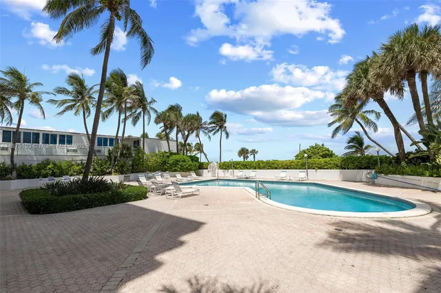 a view of a swimming pool with a sitting area
