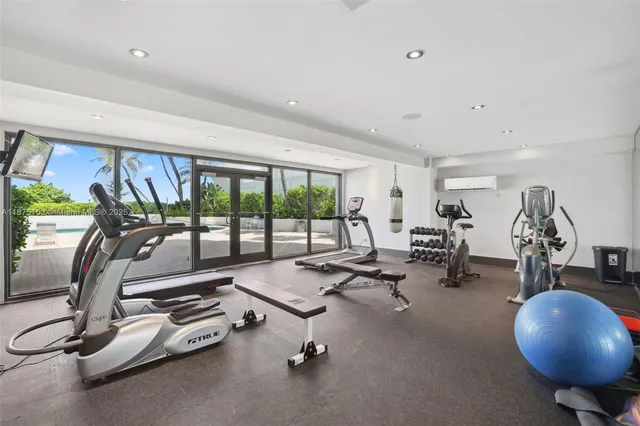 a room with gym equipment and floor to ceiling window