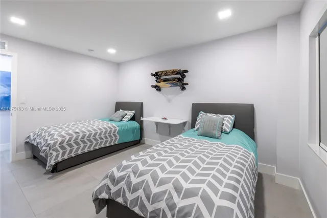 a bedroom with two beds and a lamp