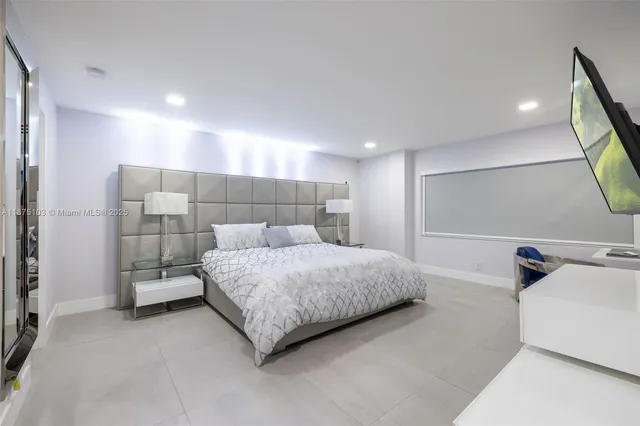 a spacious bedroom with a bed and a mirror