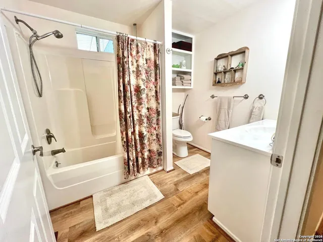 a bathroom with a sink mirror and vanity