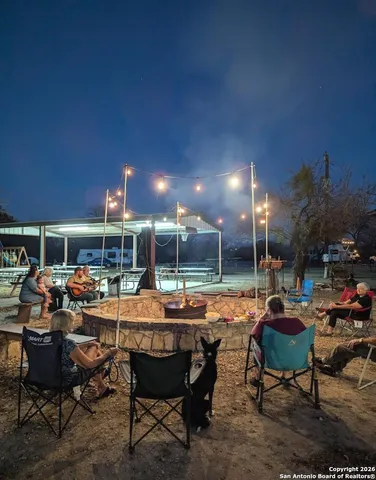 a view of a park with slide and a bench