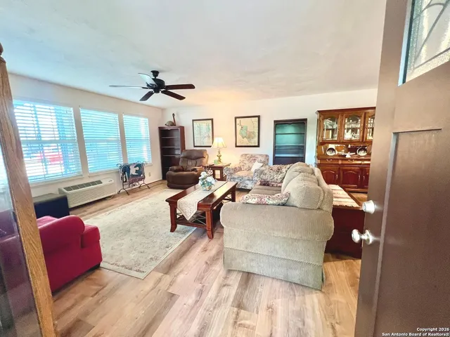 a living room with furniture and a wooden floor