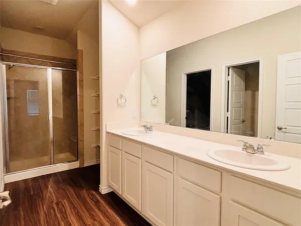 a bathroom with a double vanity sink and mirror