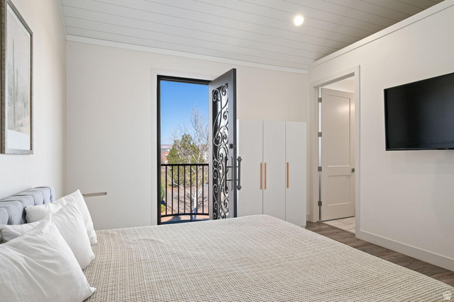 4281 Canterbury Road Hurricane, UT 84737 - Photo 19 of 24 Bedroom featuring a decorative wrought-iron balcony door, vaulted shiplap ceiling, and light wood-finish flooring