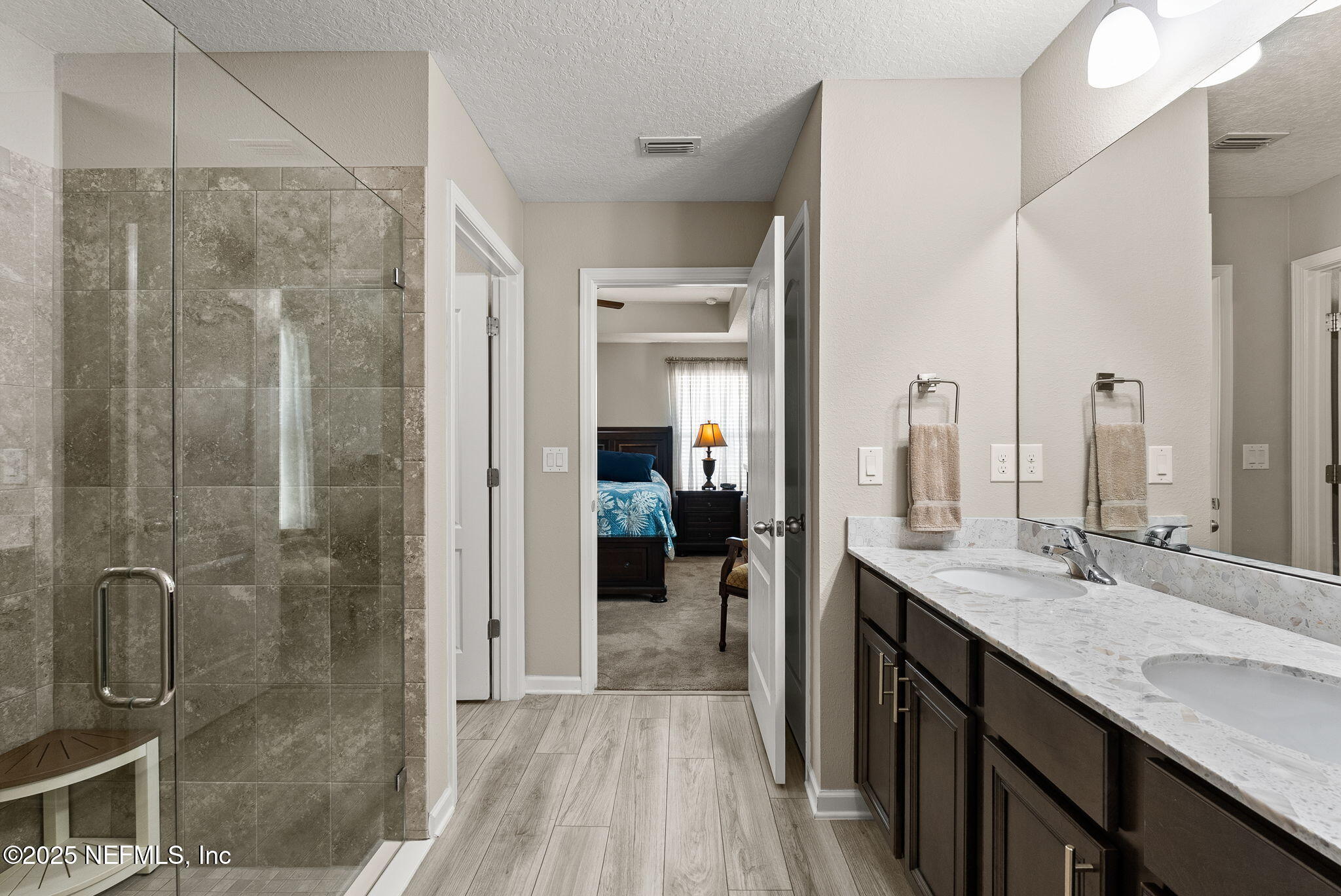 3961 Heatherbrook Place Middleburg, FL 32068 - Photo 13 of 28 a en suite bathroom with a granite countertop sink mirror and shower