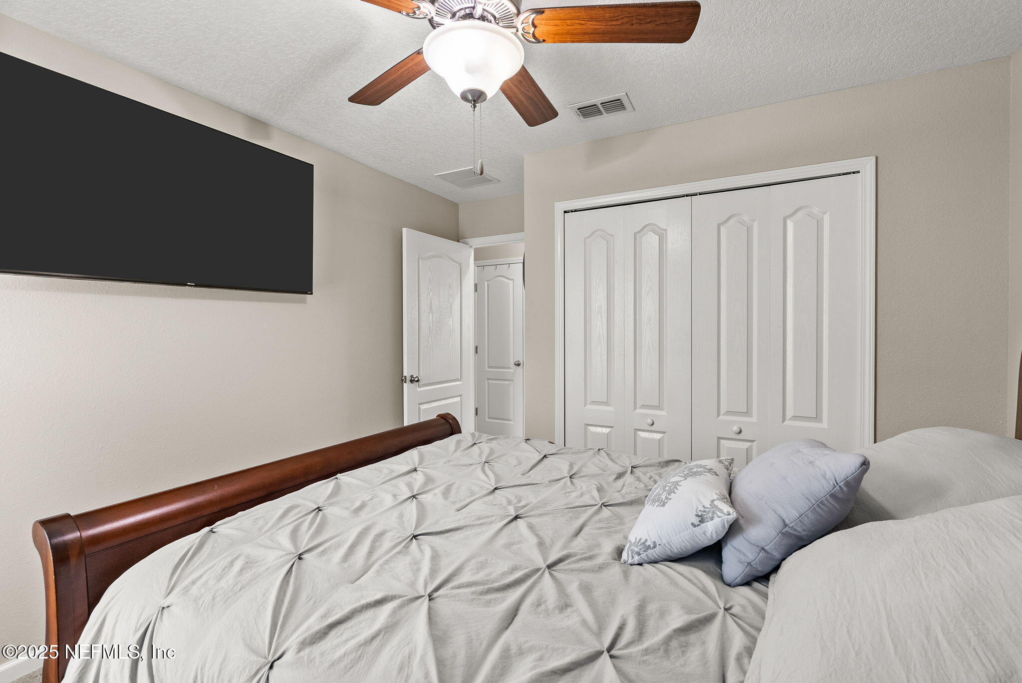 3961 Heatherbrook Place Middleburg, FL 32068 - Photo 16 of 28 a bedroom with a bed and a ceiling fan