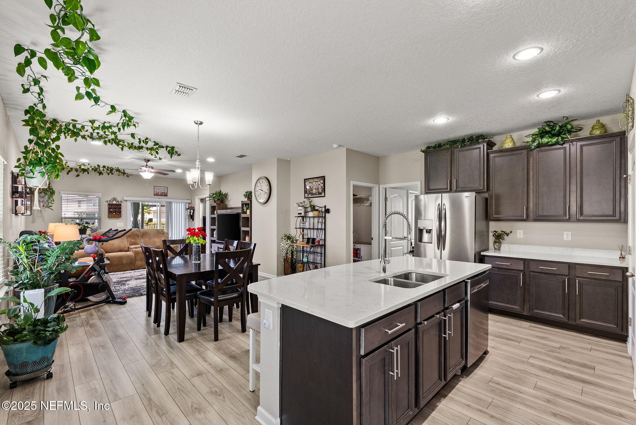 3961 Heatherbrook Place Middleburg, FL 32068 - Photo 5 of 28 a kitchen with granite countertop a center island a sink stainless steel appliances and cabinets