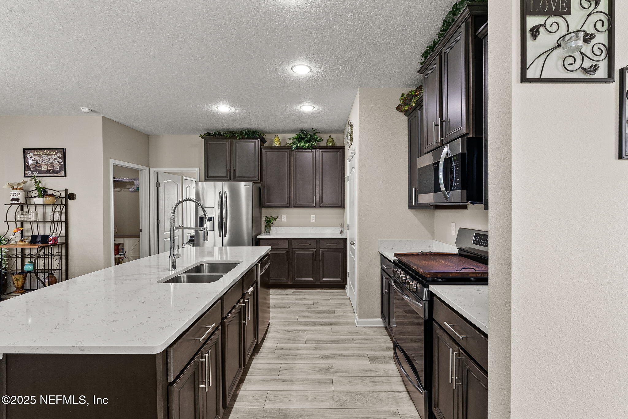 3961 Heatherbrook Place Middleburg, FL 32068 - Photo 6 of 28 a kitchen with stainless steel appliances kitchen island a sink stove and cabinets