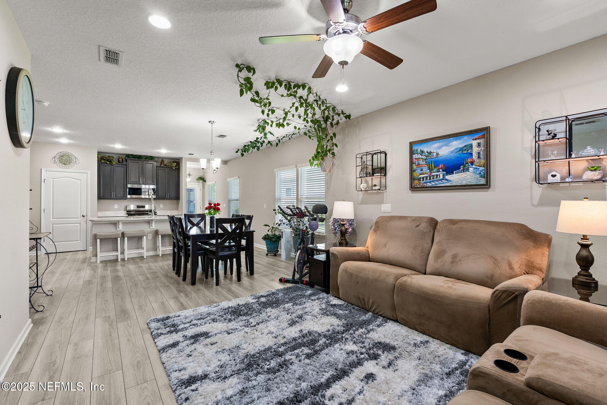 3961 Heatherbrook Place Middleburg, FL 32068 - Photo 9 of 28 a living room with furniture a chandelier and a dining table