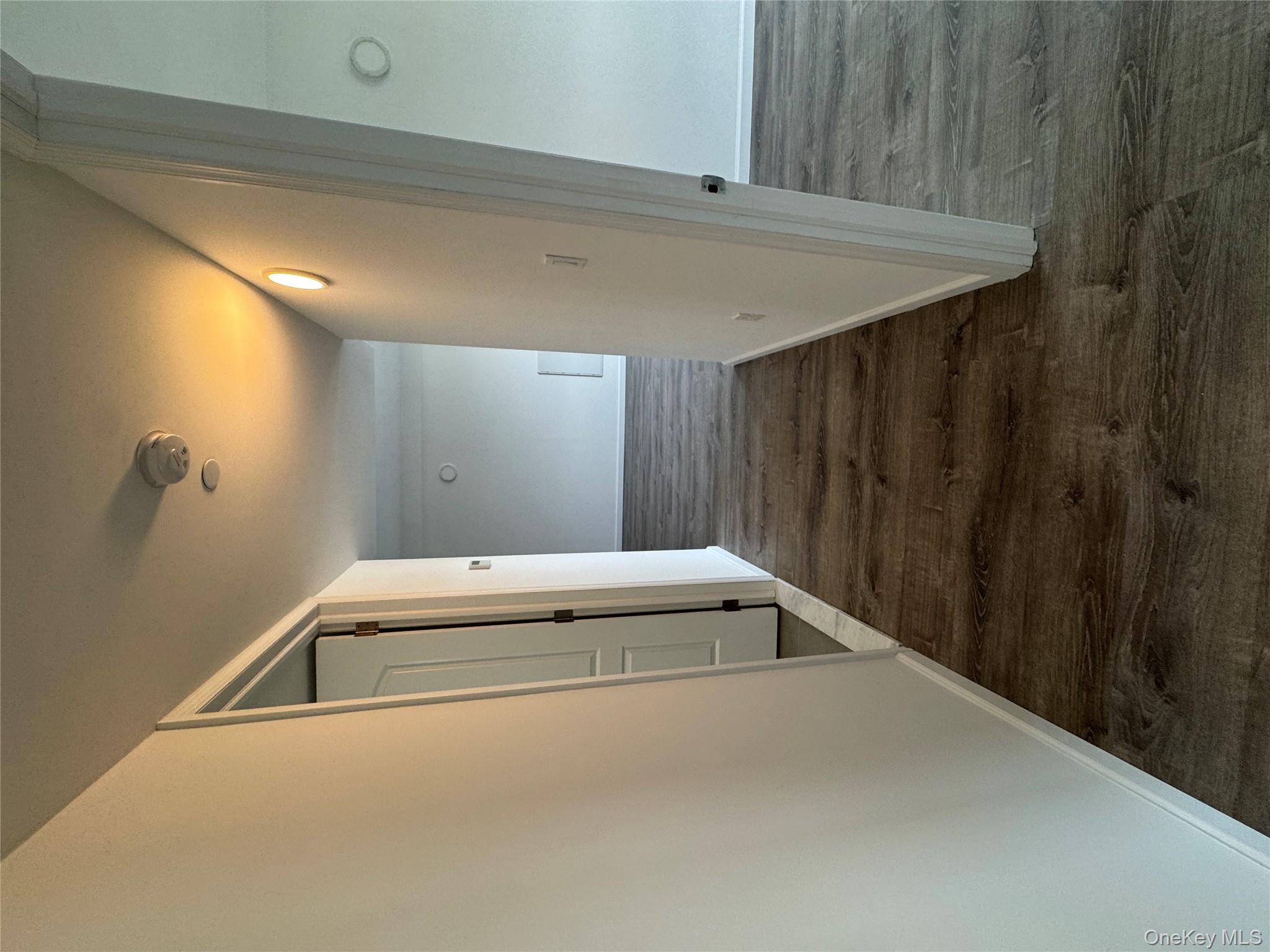 214-10 15th Avenue, Unit 3D & P6 Queens, NY 11360 - Photo 12 of 13 a view of a hallway with wooden floor and staircase