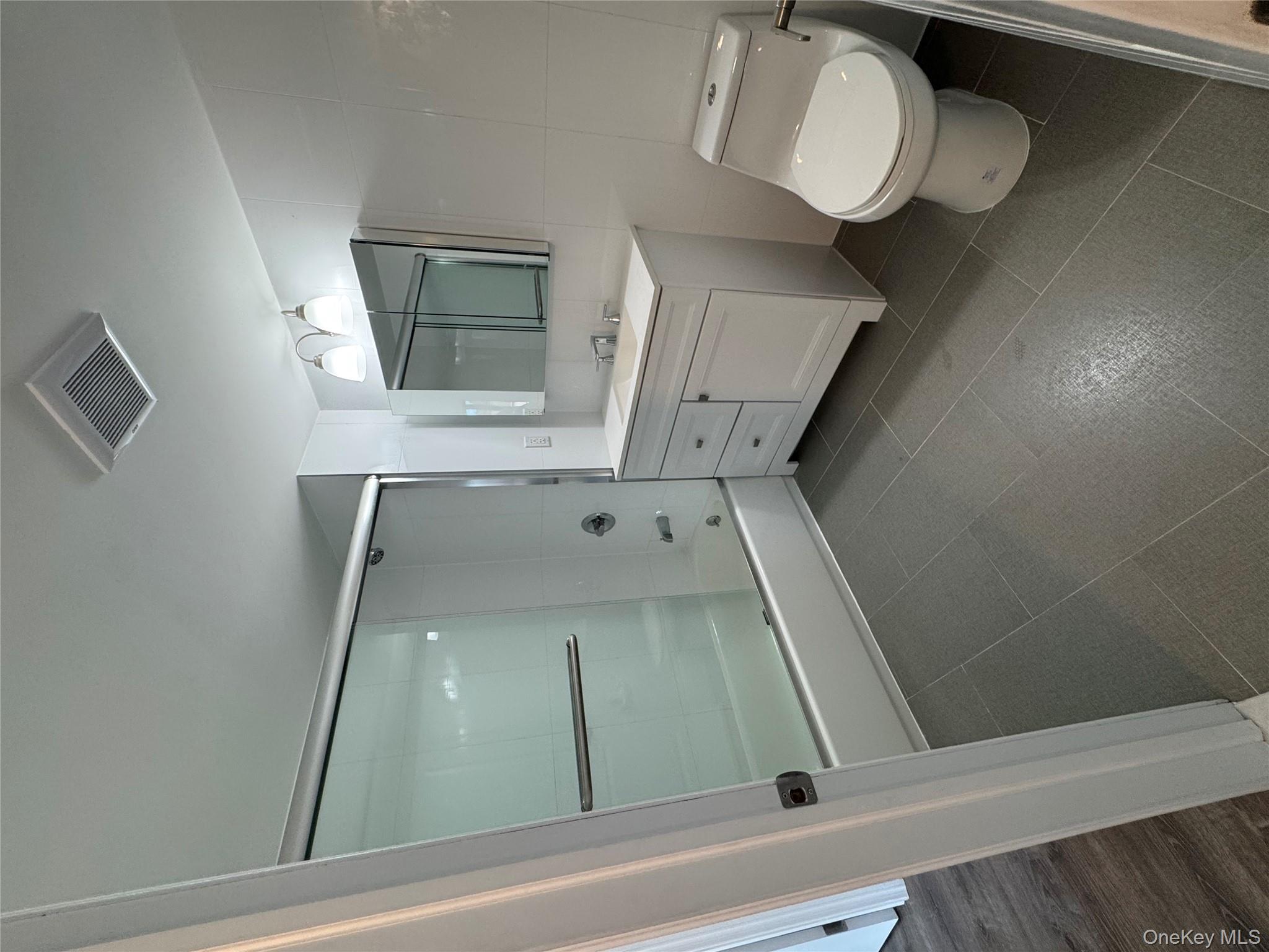 214-10 15th Avenue, Unit 3D & P6 Queens, NY 11360 - Photo 13 of 13 a bathroom with a toilet sink and shower