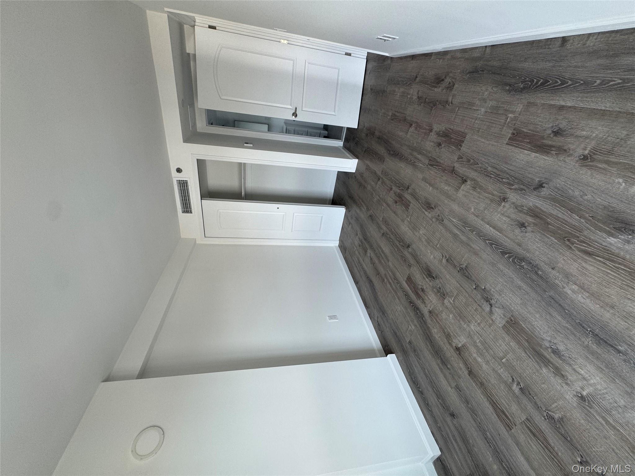 214-10 15th Avenue, Unit 3D & P6 Queens, NY 11360 - Photo 6 of 13 wooden floor in an empty room with a window