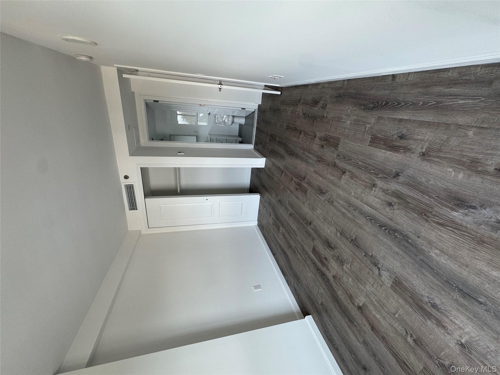 214-10 15th Avenue, Unit 3D & P6 Queens, NY 11360 - Photo 7 of 13 a view of a big room with wooden floor and closet