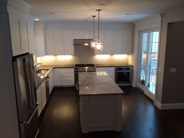 57 Upland Road Needham, MA 02492 - Photo 2 of 10 a kitchen with kitchen island a counter space a sink appliances and cabinets