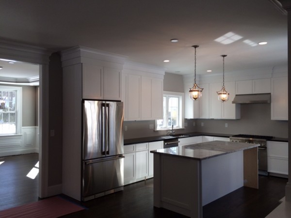 57 Upland Road Needham, MA 02492 - Photo 3 of 10 a kitchen with stainless steel appliances granite countertop a sink a stove a refrigerator and island