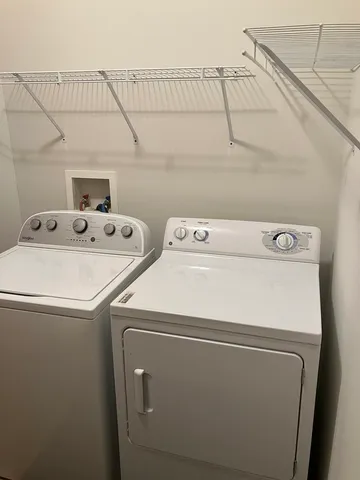 a room with water heater and shelf