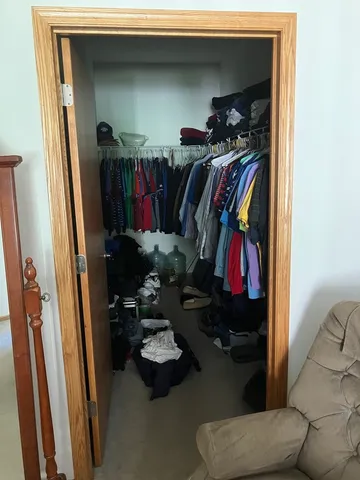 a bedroom with a bed and a mirror on the dresser