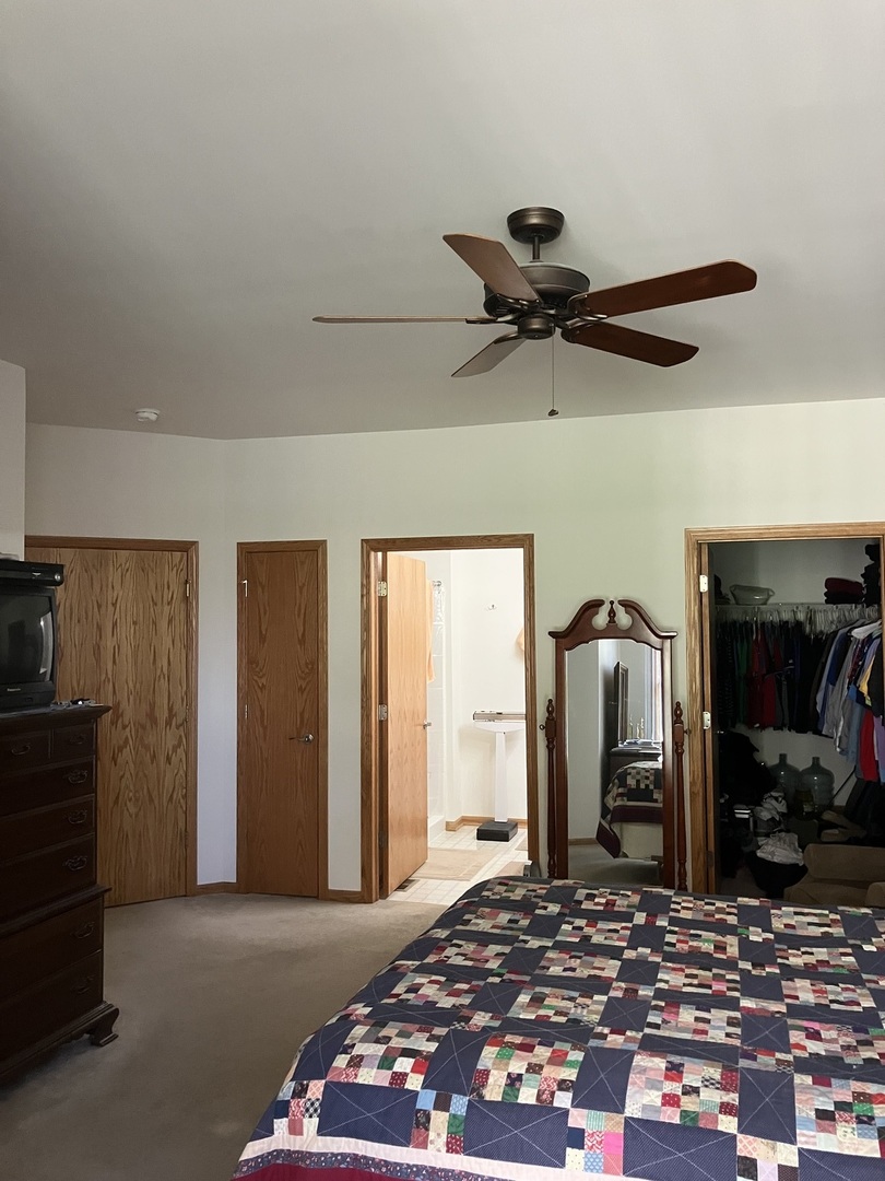 19246 104th Avenue Mokena, IL 60448 - Photo 17 of 38 a bedroom with a bed and a mirror on the dresser