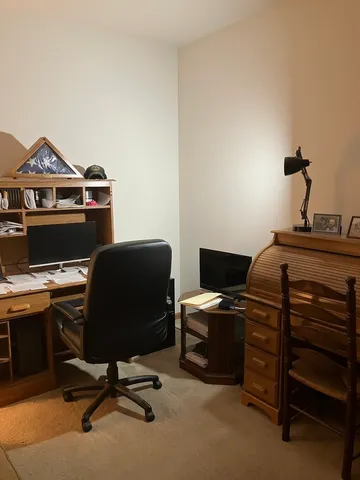 a living room with furniture and a piano