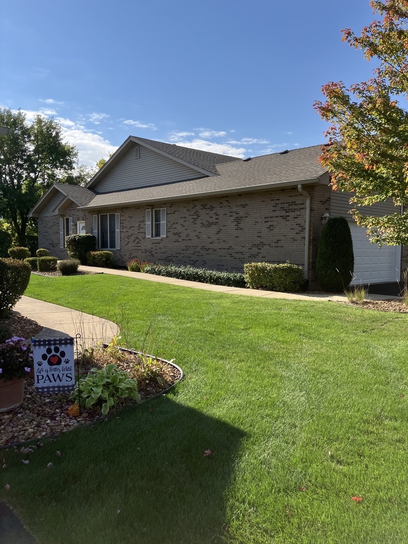 19246 104th Avenue Mokena, IL 60448 - Photo 8 of 38 a front view of a house with a yard and garage